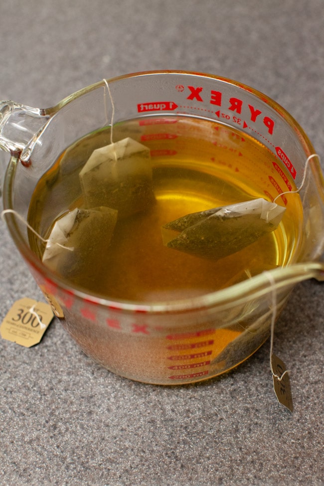 tea bags steeping in a measuring cup