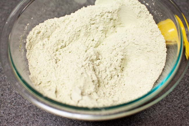 Matcha powder, flour, and salt mixed together in glass bowl for Matcha Cookies from thelittlekiitchen.com