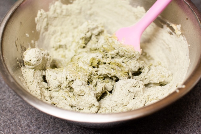 Using pink rubber spatula to mix Matcha Cookie batter in metal bowl from thelittlekiitchen.com