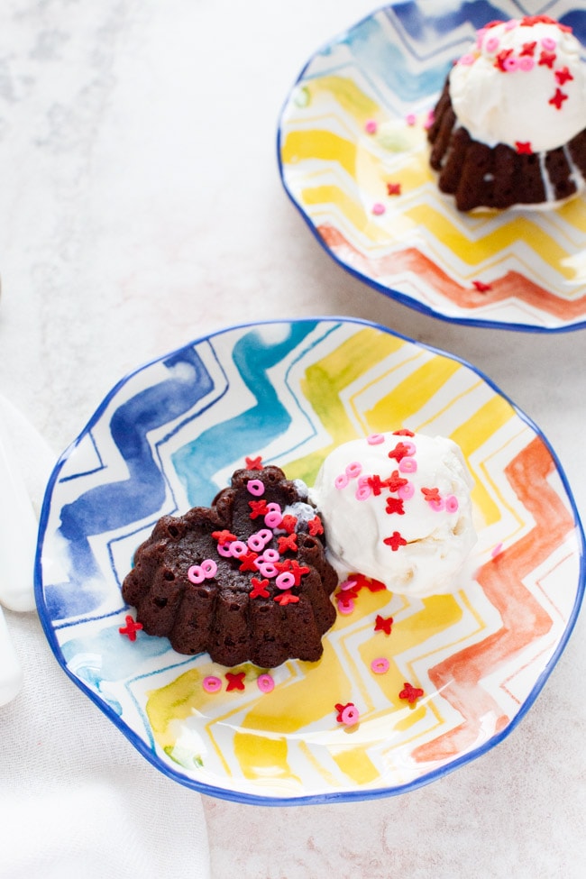 Heart Shaped Chocolate Cake from thelittlekiitchen.com heart shaped chocolate cake with vanilla ice cream on a plate with another plate in the background