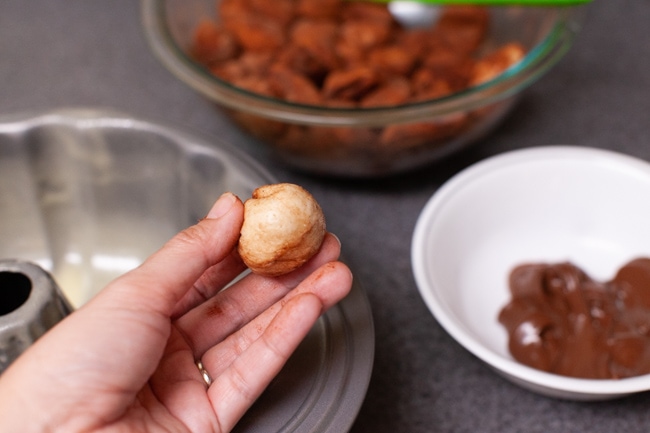 a hand holding Monkey Bread dough